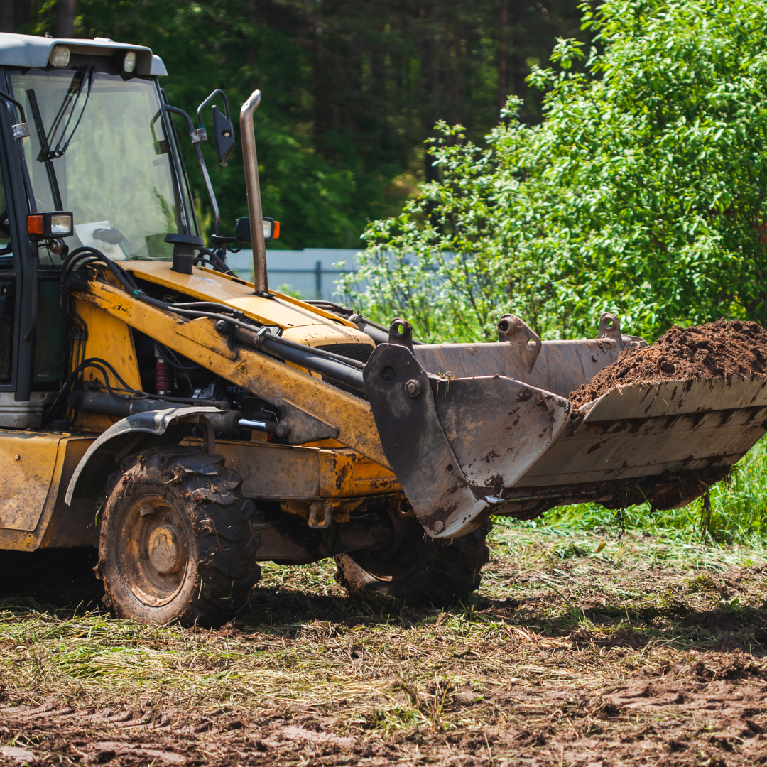 Front loader moving debris